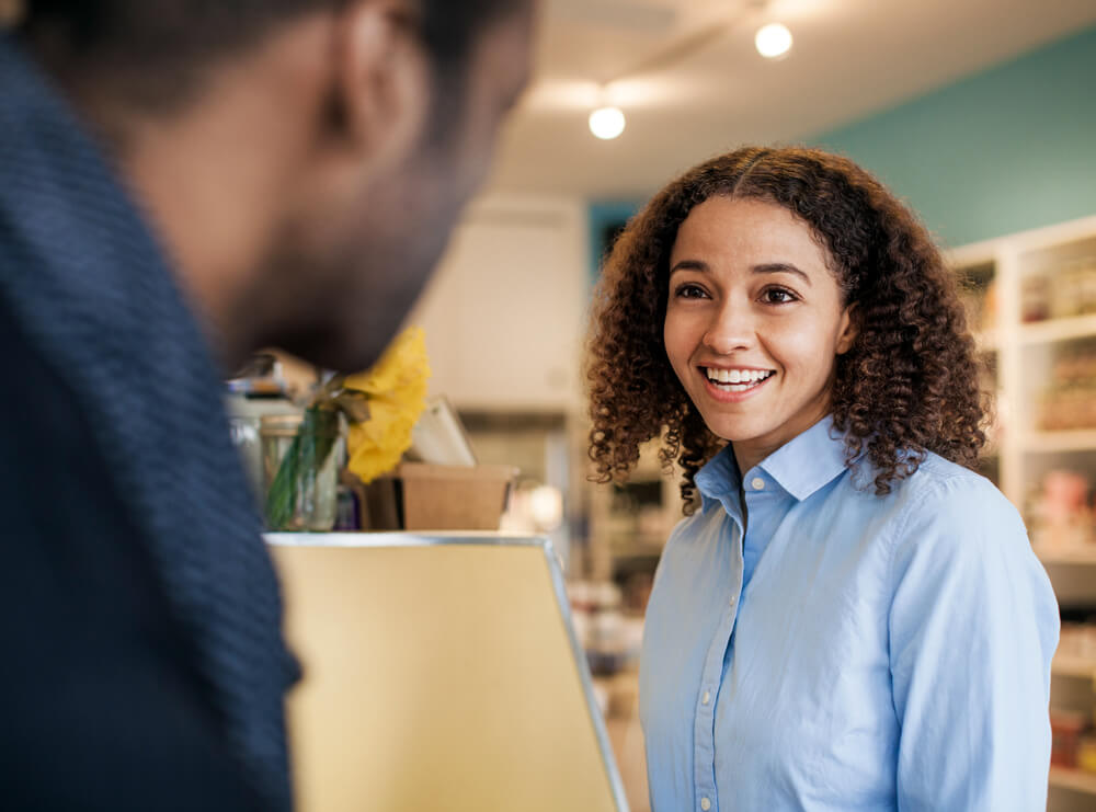 a woman and man talking about business review management solutions