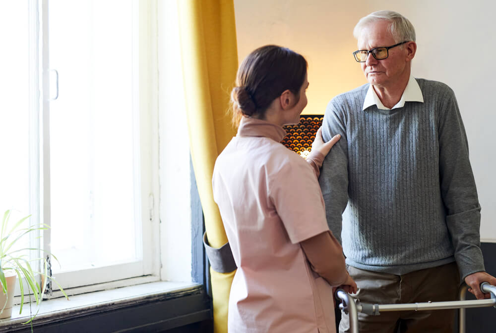 senior citizen talking to a care taker